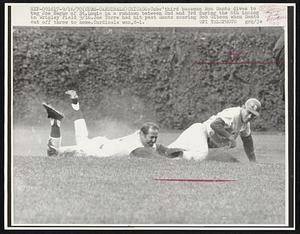 Cubs' third baseman Ron Santo dives to tag Joe Hague of St. Louis in a rundown between 2nd and 3rd during the 6th inning in Wrigley Field 9/16. Joe Torre had hit past Santo scoring Bob Gibson when Santo cut off throw to home. Cardinals won, 8-1.