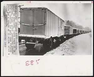 Stalled Convy -- Trucks, bumper to trailers, lined route 20 in Charlton, Mass. After jacknifed trucks help up traffic for more than fifteen hours for a length of 35 miles, after a “sneak” snowstorm.