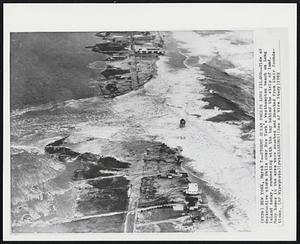 Stormy Ocean Sweeps Long Island--Tide of destructive storm rolls over New York's Westhampton beach on Long Island today, connecting with the bay behind the strip of land. Many homes in the area were smashed and knocked from their foundations.