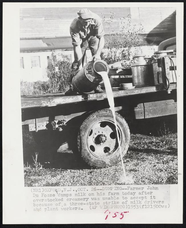 Dumping--Farmer John Du Fosse dumps milk on his farm today after overstocked creamery was unable to accept it because of a three-state strike of milk drivers and plant workers.