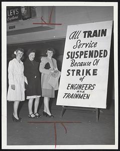 Where Was Bad News Last Night--when this sign, announcing suspension of service, was posted at the North Station. These girls, who live within bus or street car distance, don't look too downhearted. Left to right--Jenn McDonald, Charlestown; Abbey Barnes, Charlestown, and Evelyn Hazlett, West Medford.