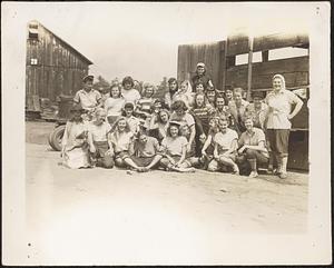 A group of young workers outside a tobacco barn
