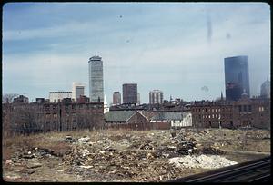 Piles of garbage, possibly from a demolished building, Prudential Tower and new John Hancock building in background