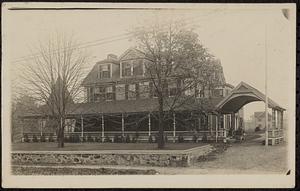 Postcard of a Victorian house with a porte cochere