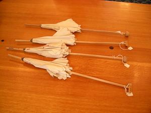 Four parasols on wooden surface