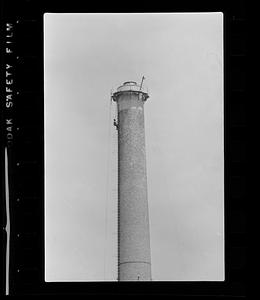 Steeplejack on factory chimney, Boston