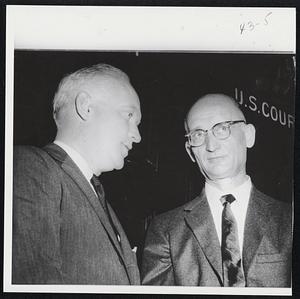 Word of Advice--Russian Col. Rudolf Abel, indicted on charges of spying for Russia, listens to court-appointed counsel, James P. Donovan, (left) in corridor of Federal court, Brooklyn, N.Y.