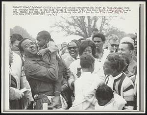After dedicating "Resurrection City" in West Potomac Park for housing members of the Poor People's Campaign 5/13, the Rev. Ralph D. Abernathy greets Mrs. Minnie Lee Hill and her eight children, who will live in the first dwelling to be erected.