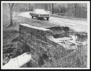 Car driving toward rushing water