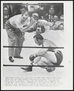 The Long Count--Referee Billy Regan leans over challenger Ingemar Johansson as he counts him out in the sixth round of tonight's title fight with heavyweight champion Floyd Patterson at Miami Beach. Johansson was floored with a chopping right to the jaw. He started to rise midway in the count, at the count of nine started to rise again but fell back to the canvas. The time was 2:45 of the sixth round.