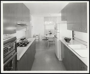 Friendly Kitchens are back – but there’s nothing old-fashioned about the materials that now make them look inviting. In this model room, for example, woodgrain plastic is used for all cabinet doors and countertops. The result is a cheerful, homelike atmosphere, calling for a minimum of upkeep and core.