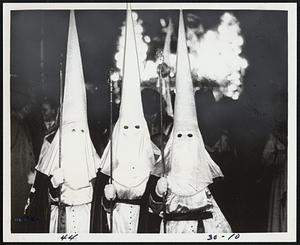 "To Die in Madrid", the documentary film of the Spanish Civil War of three decades ago has what appear to be members of the Ku Klux Klan marching through the streets. Actually the hooded figures are part of a religious order. The film is currently at the Paris Cinema.