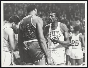 Bill Russell speaks to another player wearing number 13