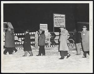 Pickets led by John Deady, secretary of the Metropolitan Building Trades Council, AFL-CIO, (far left) patrol the shaft of the new East Boston tunnel job in a jurisdictional dispute involving several unions. Twenty Boston policemen mingled with the pickets in 10-degree cold today after receiving reports of possible violence.