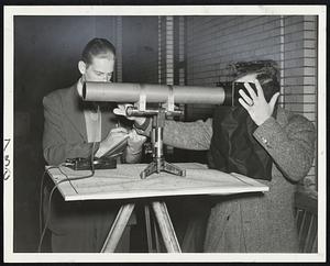 Checking on the Sky Glow-This light-measuring instrument was used atop the court house last night to get a line on how much sky glow was left on Boston's blackout. James E. Georgalos and Charles P. Woras are taking the figures.