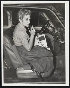 Civil Defense in Herald Radio Car--Mrs. Irma Levine, Brookline Civil Defense worker, talking to her headquarters over CD equipment she placed in a Herald car to be close to sources of information about the hurricane.