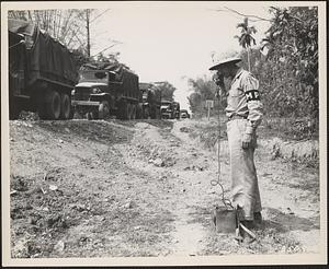 A member of the 167th Military Police Company at the vehicle depot, Chabua, Assam, India, receives the latest reports on convoy movements