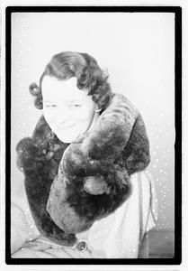 A woman with a fur scarf around her neck