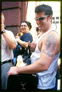 Boston - N. End 2002 - A man carries at duck on the sidelines of the procession of St. Anthony's Feast