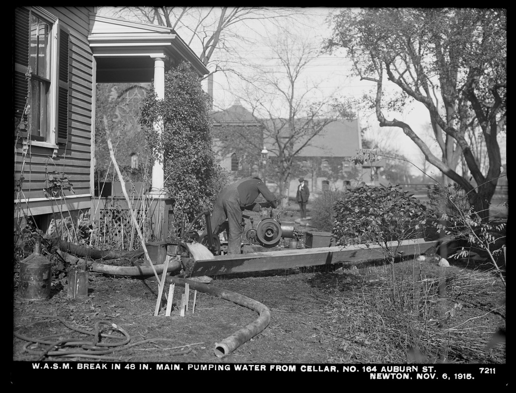 Distribution Department, Weston Aqueduct Supply Mains, break in 48-inch main, pumping water from cellar at No. 164 Auburn Street, Newton, Mass., Nov. 6, 1915