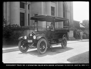 Distribution Department, Emergency Truck No. 2, operating valve with device attached to motor in front of Chestnut Hill Low Service Pumping Station, Brighton, Mass., Jul. 14, 1916