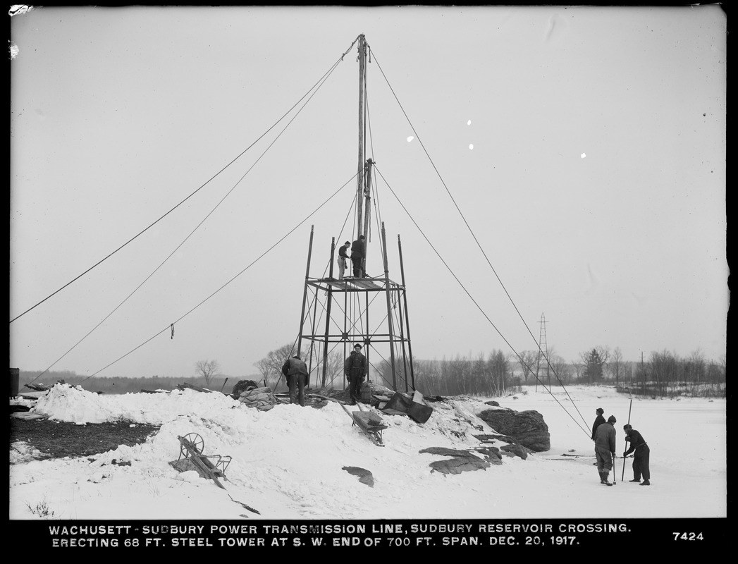 Wachusett Department, Wachusett-Sudbury power transmission line, Sudbury Reservoir crossing, erecting 68-foot steel tower at southwesterly end of 700-foot span, Southborough, Mass., Dec. 20, 1917