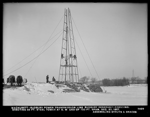 Wachusett Department, Wachusett-Sudbury power transmission line, Sudbury Reservoir crossing, erecting 68-foot steel tower at southwesterly end of 700-foot span, assembling struts and braces, Southborough, Mass., Dec. 20, 1917