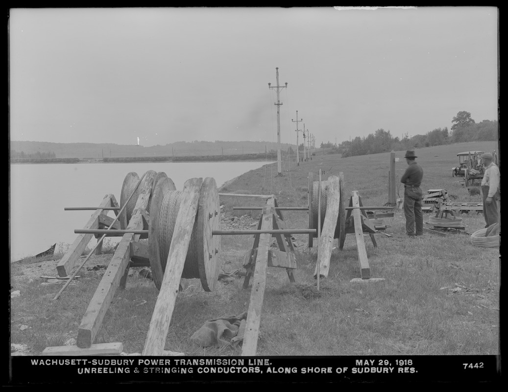 Wachusett Department, Wachusett-Sudbury power transmission line, unreeling and stringing conductors along shore of Sudbury Reservoir, Southborough, Mass., May 29, 1918