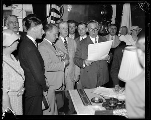 Governor Curley shown signing oath bill