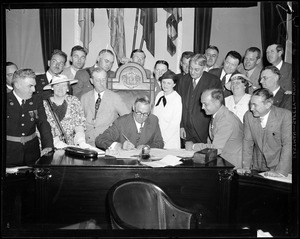 Governor Curley shown signing oath bill