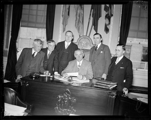 Governor Curley shown with Philip Russel, Daniel Coakley, Lt. Gov. Hurley, James J. Brennan, + W.C. Hennessey