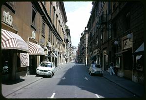 Street lined with storefronts, Rome, Italy