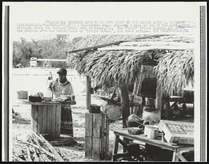 A Miccosukee woman prepares a meal at one of the many Indian villages along the Tamiami Trial West of Miami, Fla. The "Trail" (State highway 41) links the Indians with the inhabitants of "Little Havana", the Cuban refugee.