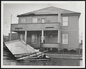 Storm Lashed Coast-The roof of the top piazza of this house at 120 Shore Drive in Winthrop, lies in the street after being lifted by the northeast gale.