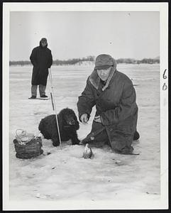Fun in Winter - It's fun, but it's frigid to fish in the ice. Here, among the thousands of frozen lakes in Minnesota, a fisherman just chops a hole and drops his line - no oars to tug, no anchor to weigh.