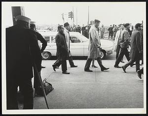 People walking down the street, probably at an anti-war demonstration