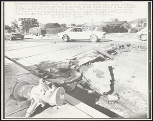 Traffic is disrupted on the main street of Sylmar, Calif.. as a fire hydrant and buckled pavement on the street attest to the movement of earth caused by the massive earthquake that struck Southern California early 2/9. Numerous deaths, injuries, and millions if dollars in damage were reported as rescue efforts went into operation throughout Southern California.