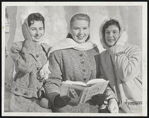 Catching Up on their studies is this group of Chandler School students, chilled through but happy while waiting for a bus. Left to right, Doris Marchant, and Maybelle Wallin, both of Westwood, and Nancy Keating, West Roxbury.