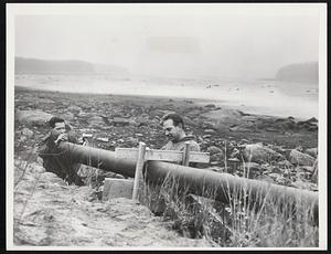 Leominster, Mass.- Emergency Pipe-- Workers (l. to r.) Fabio Battazzi, Jr. and James DiPrima finish work on last section of emergency pipe-line from Sawmill Pond in Fitchburg to nearly empty Norton Reservoir (background). Officials expect to obtain 1.5 million gallons a day using pipe-line to replenish water supply.