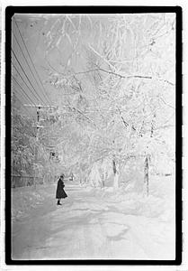 A person standing on a snow covered street