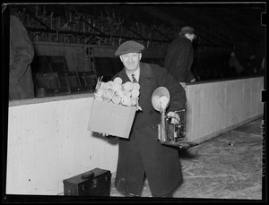 L.J. [Leslie Jones] with speed graphic, flash bulbs, negative box on the ice at the Garden