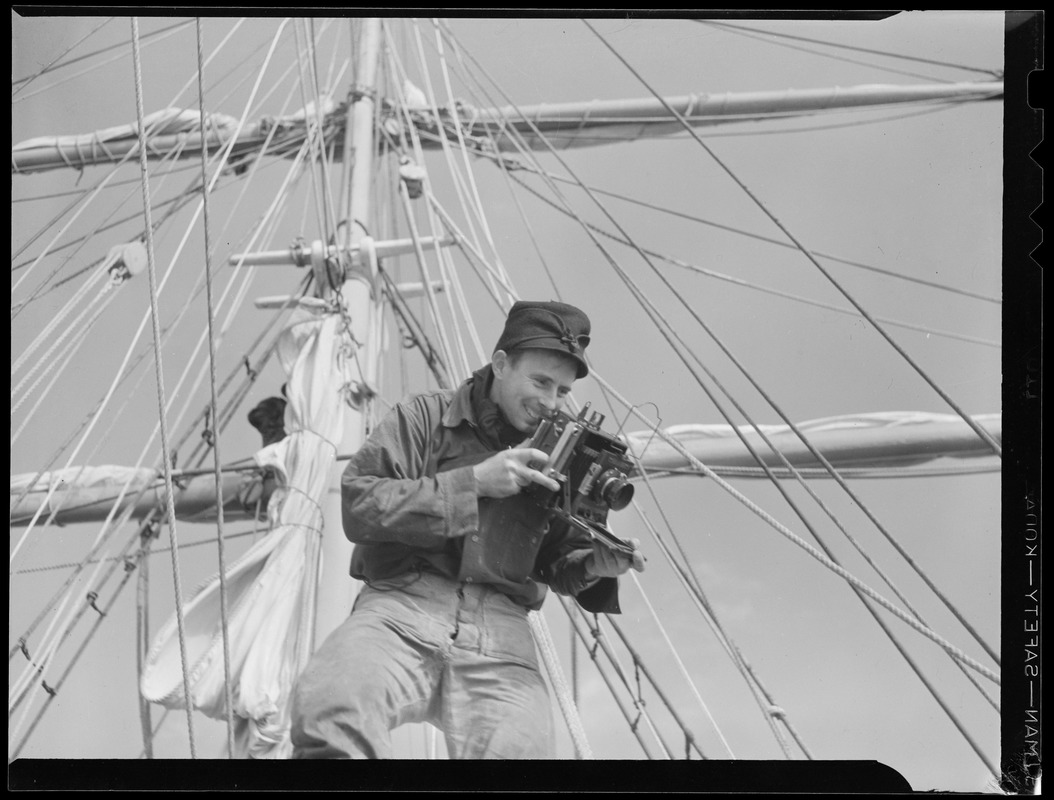 Man in rigging with camera