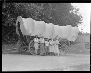 Unidentified group near covered wagon