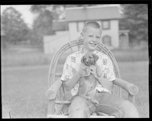 Unidentified boy with puppy