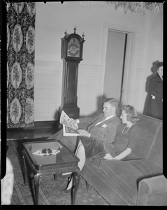 Unidentified man and woman reading on couch