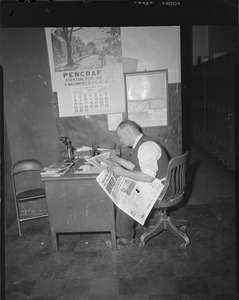 L.J. [Leslie Jones] reading the newspaper in Herald photography office