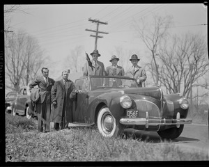 Leslie Jones with group of unidentified men and automobile