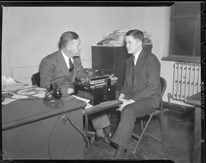 Possibly reporter at desk