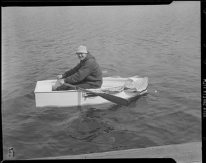 Men launch tiny row boat, Charles River