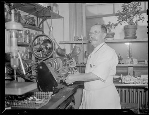 Man in boat shop working grinder